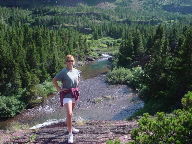 Janine Bodway standing on a ledge above a western montana river
